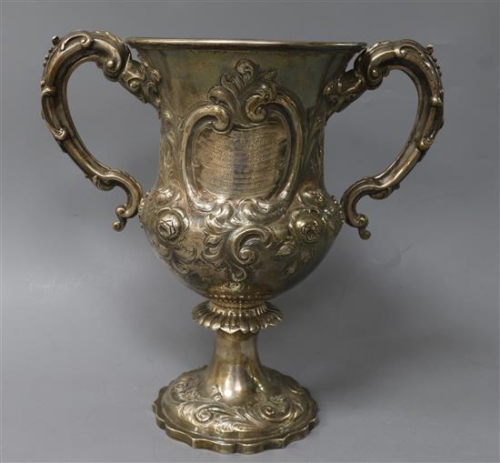 A Victorian embossed silver two handled presentation trophy cup, William Smily, London, 1863, 25.5 oz.